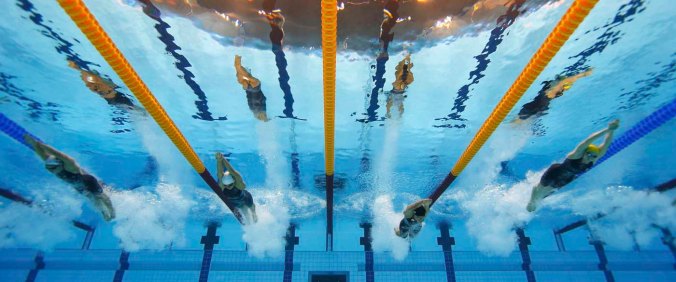 Competitors swim in the women's 200m butterfly heats during the London 2012 Olympic Games